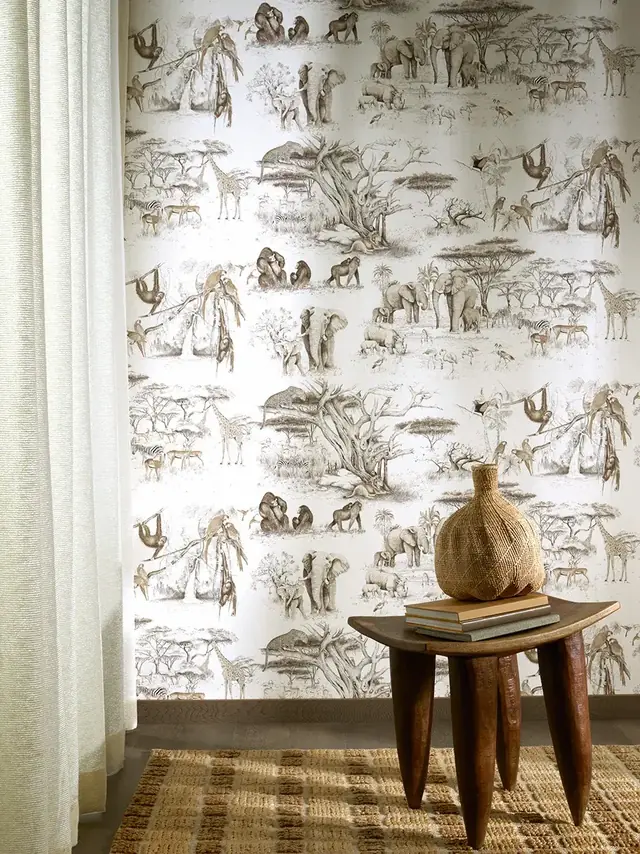 Neutral safari animal wallpaper featuring elephants, giraffes and monkeys in an elegant interior