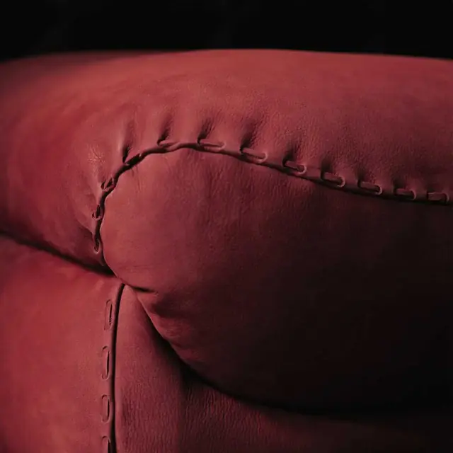 Close-up of stitched burgundy nubuck leather upholstery