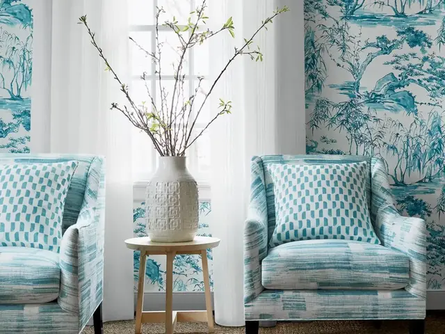 Blue and white Anna French Kyoto wallpaper in an elegant sitting area