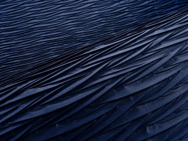 Close-up of deep blue Arte Origami wallcovering showing its folded relief and textured surface