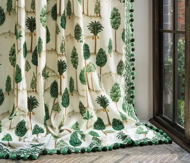 Osborne & Little patterned curtains finished with decorative braid and pom-pom trimming