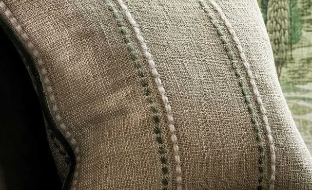 Osborne and Little patterned and textured cushions in blue and neutral tones
