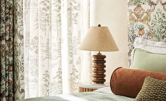 Osborne and Little sheers and patterned fabric within a softly layered bedroom