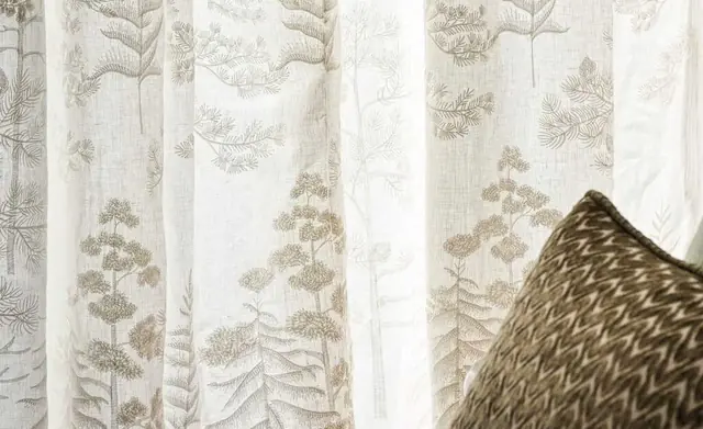 Osborne and Little Vana sheer curtain fabric in a softly furnished bedroom