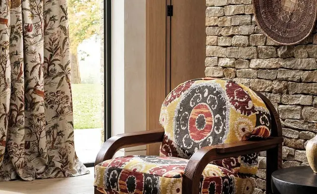 Osborne and Little patterned curtains and upholstery in a characterful interior