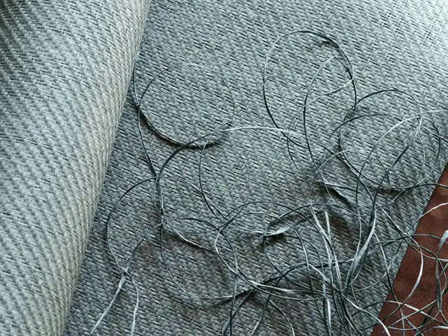 Close-up of blue paperweave fibres showing yarn, knots and loose paper threads