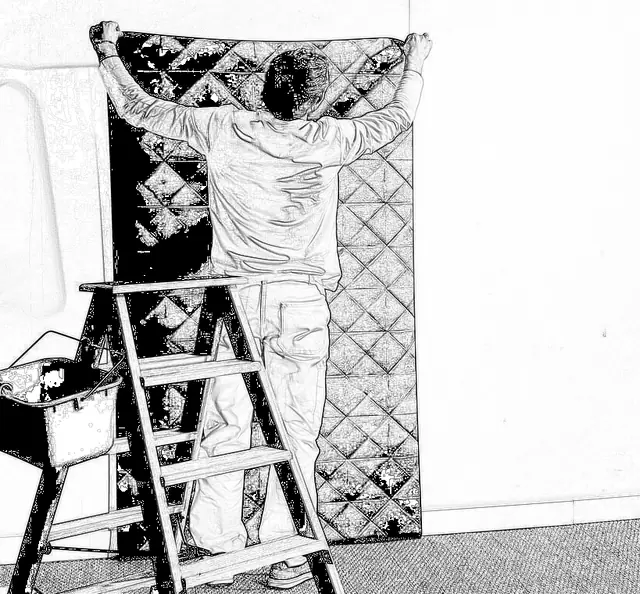 Hanging a dry strip of non-woven wallpaper onto a pasted wall