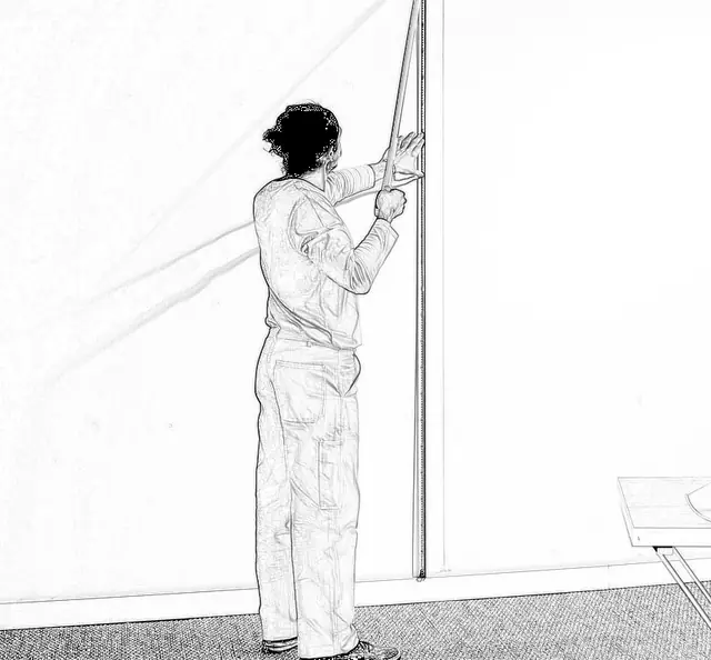 Measuring wall height before cutting a wallpaper length