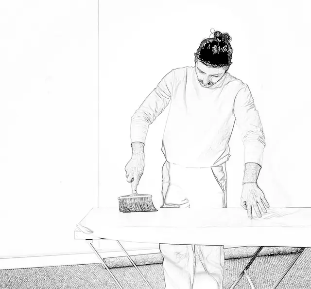Applying wallpaper paste to the back of a paper-backed wallpaper length