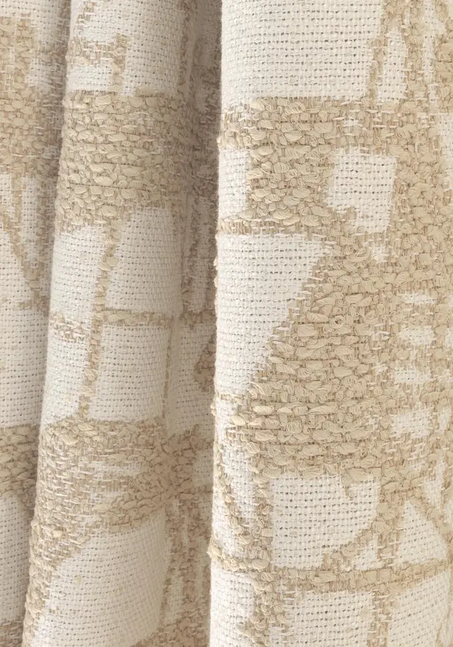 Cream and beige patterned bouclé fabric showing its looped woven texture
