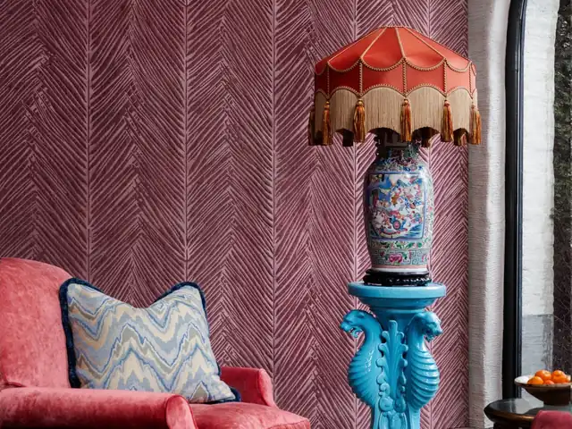 Plum geometric wallpaper in a colourful layered interior