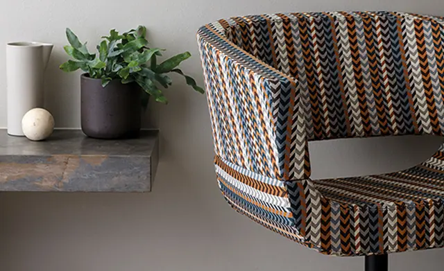 Patterned Trevira contract upholstery fabric on a rounded armchair