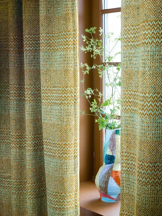 Patterned wool-blend curtains in teal and warm ochre tones
