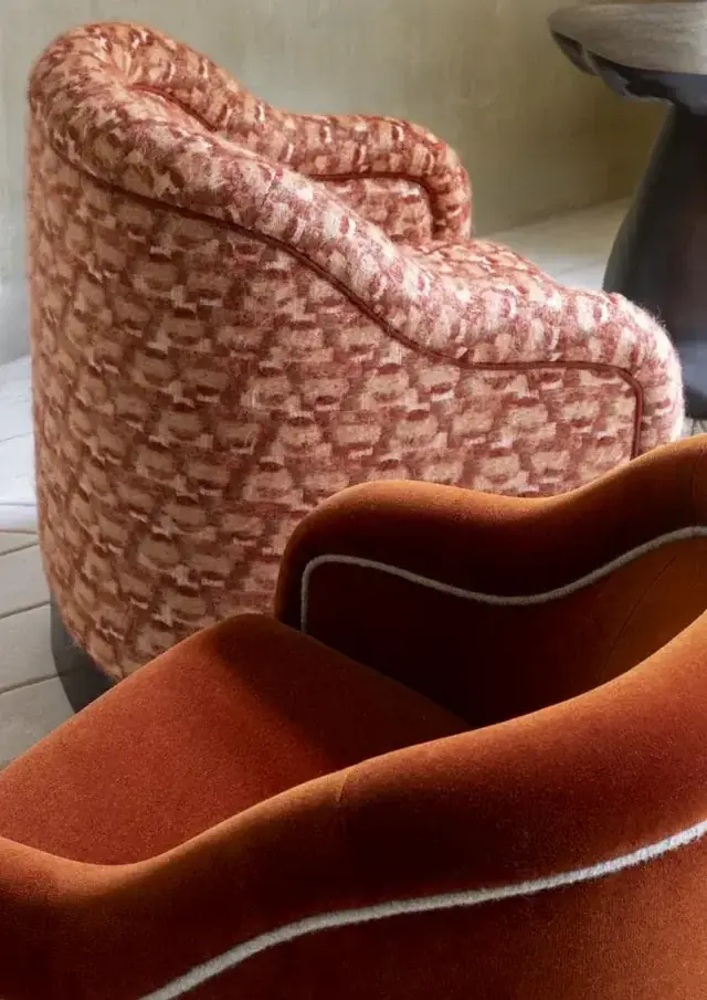 Patterned and plain designer upholstery fabrics on sculptural lounge chairs