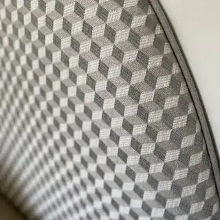 Chamfered upholstered headboard with piped edge