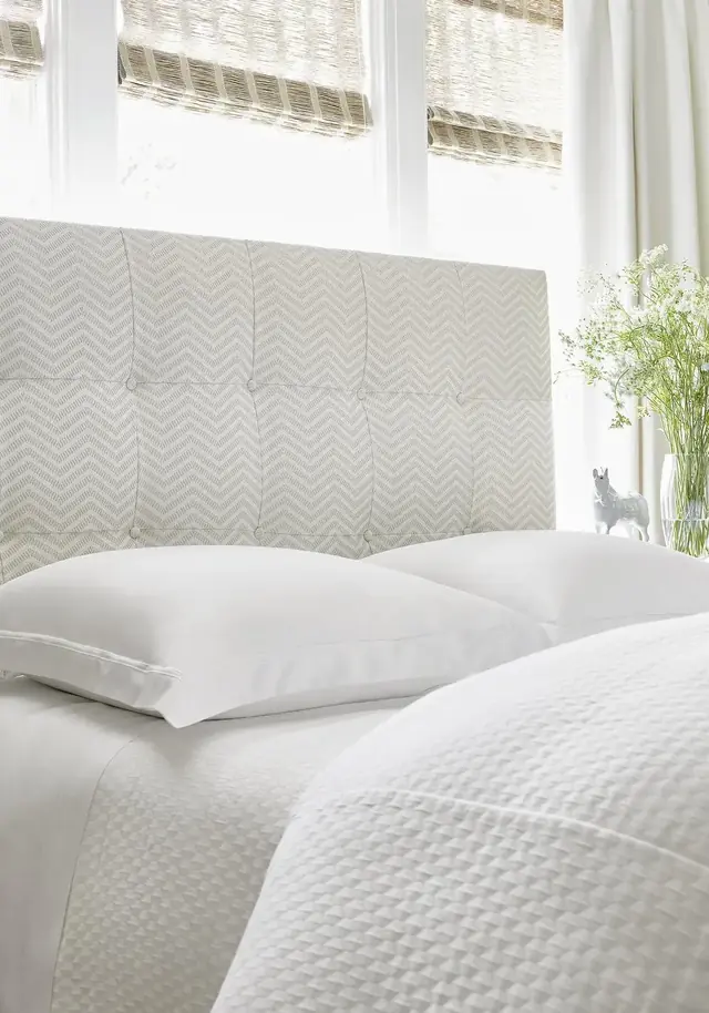 Neutral textured fabric on a contemporary upholstered headboard