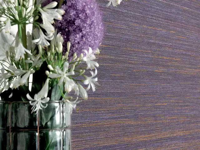 Purple wallcovering close-up showing violet threads and tonal variation