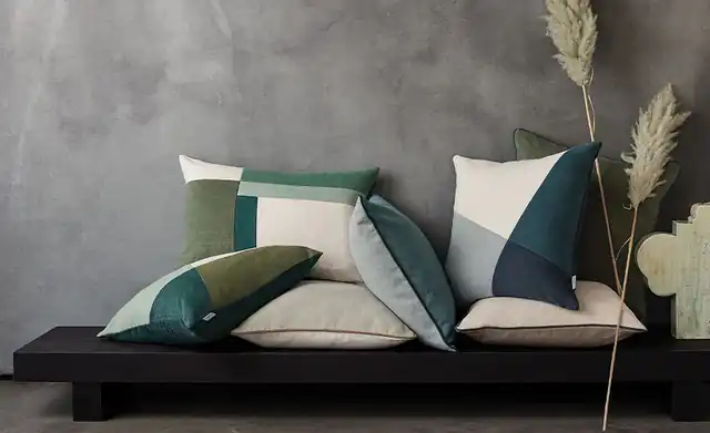Plain and geometric patchwork Romo Linara cushions in green, teal and neutral shades