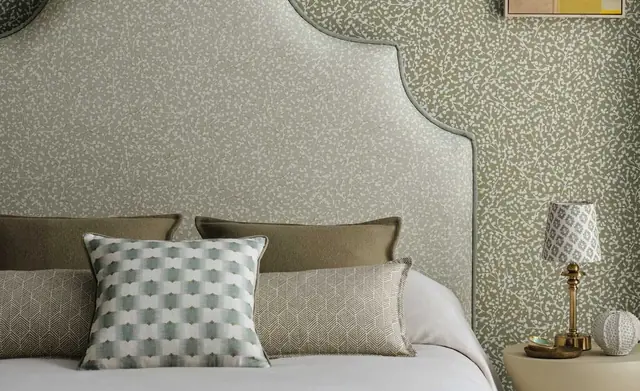 Romo fabric used across an upholstered headboard, cushions and bedroom furnishings
