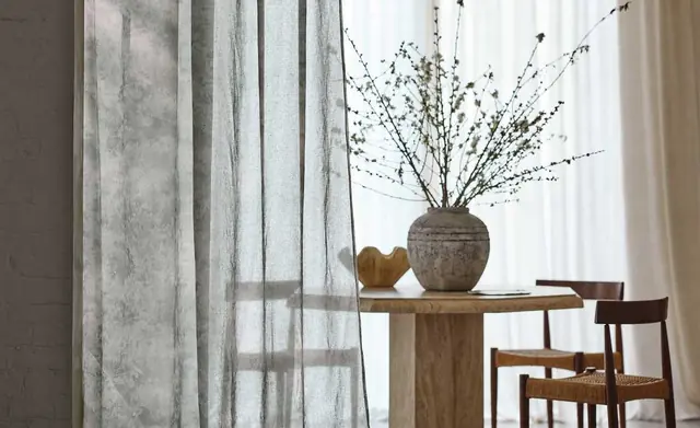Lightweight Romo sheer curtains filtering daylight in a calm dining room
