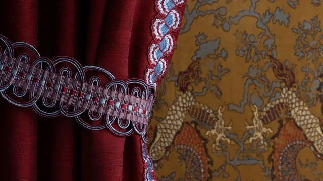 Samuel & Sons decorative trim and tieback on a red curtain