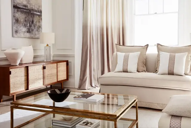 Full-length satin curtains framing a softly furnished contemporary living room