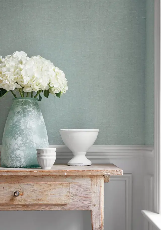 Soft blue-grey semi-plain wallpaper with understated tonal texture
