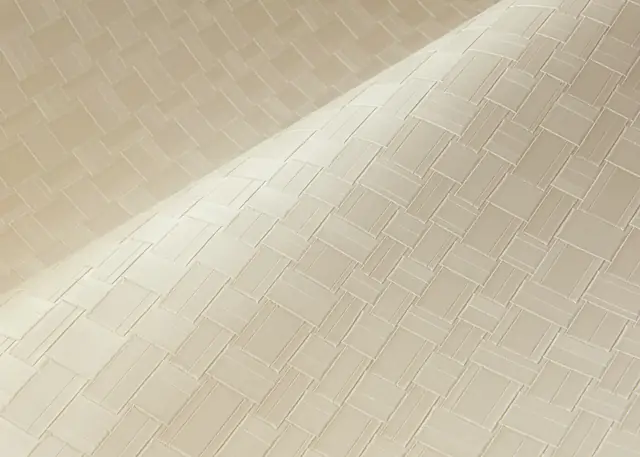 Close-up of cream semi-plain wallpaper showing a small woven repeat and surface relief