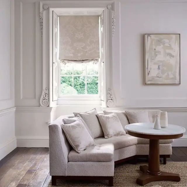 Pale patterned silk-blend Roman blind in an elegant living room