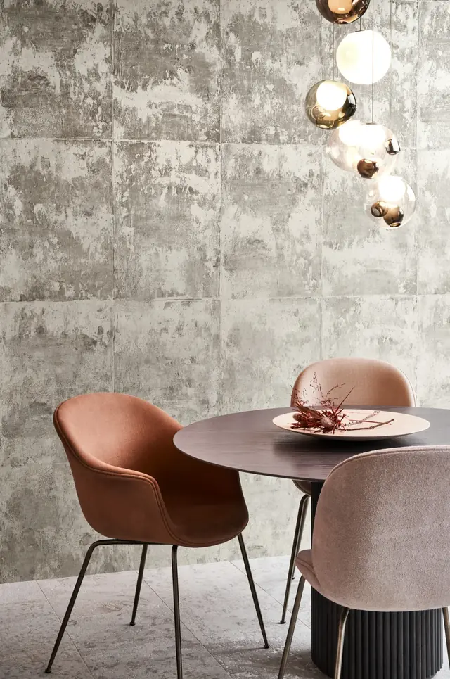 Silver metallic wallpaper with weathered block texture in a contemporary dining interior