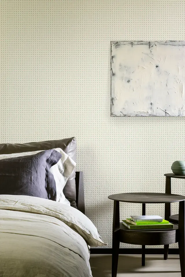 Small red dots arranged across neutral wallpaper in a contemporary room
