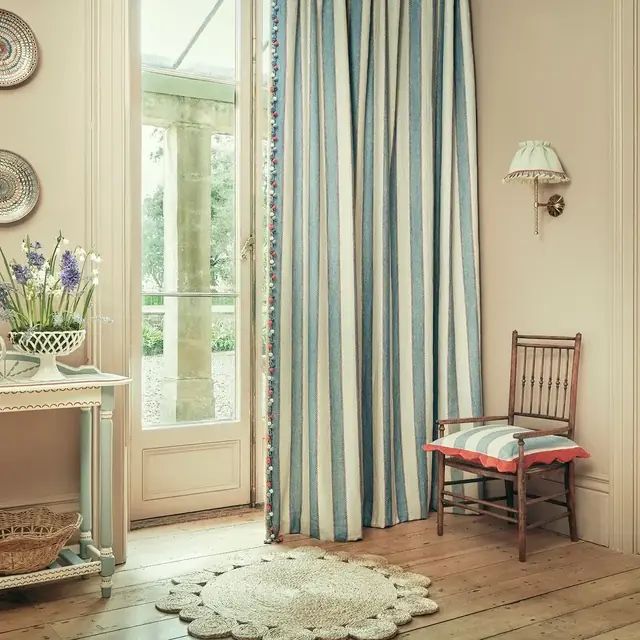Blue and neutral striped curtain fabric in a traditional room