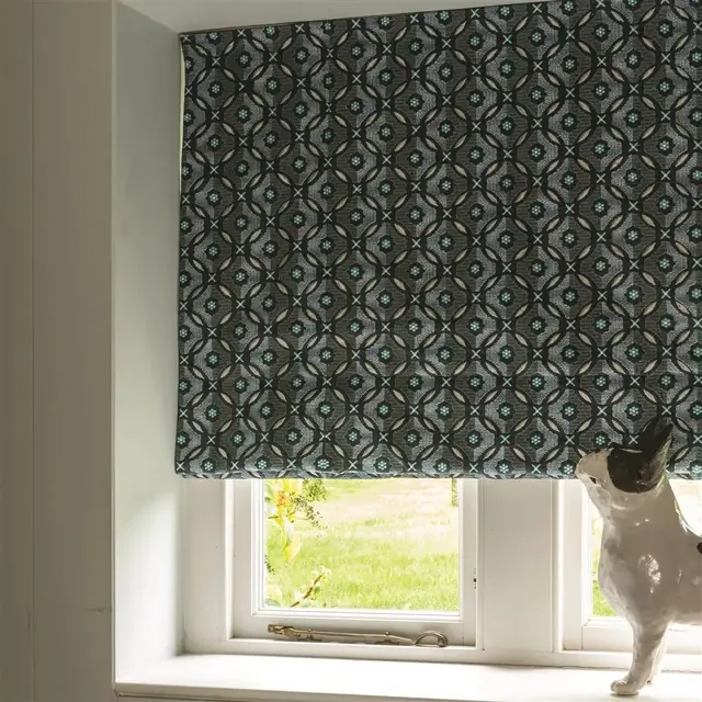 Blue patterned Roman blind fabric forming a sequence of horizontal folds