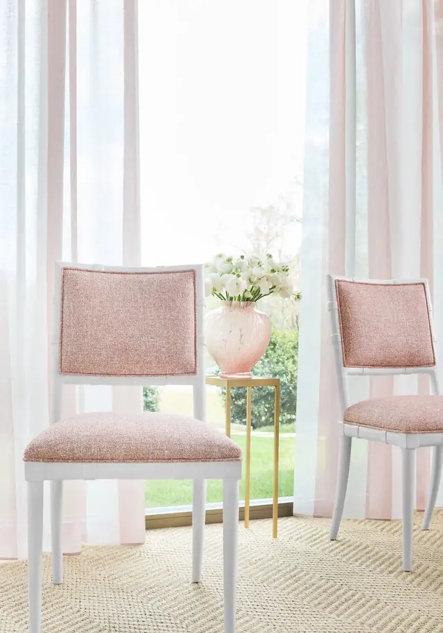 Neutral striped voile curtain fabric filtering light at a window