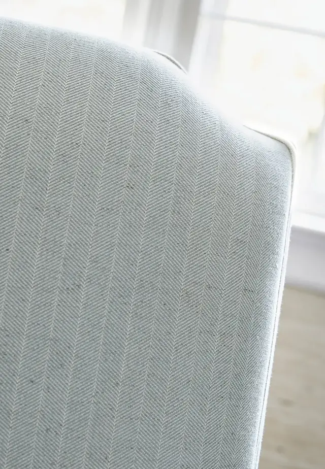 Neutral herringbone fabric used on upholstered seating