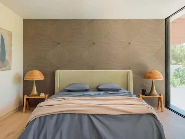 Soft dimensional textile wallcovering behind a bed