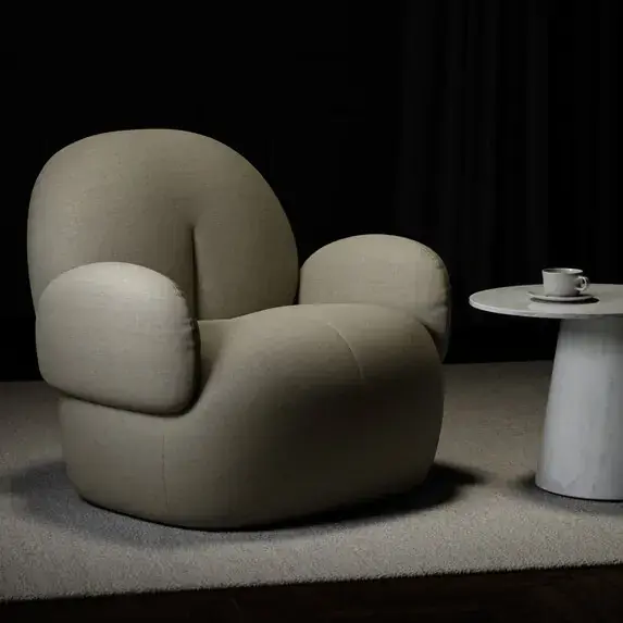 Contemporary rounded armchair upholstered in neutral textured chenille fabric