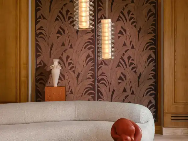 Deep brown embroidered textile wallcovering with an organic botanical design