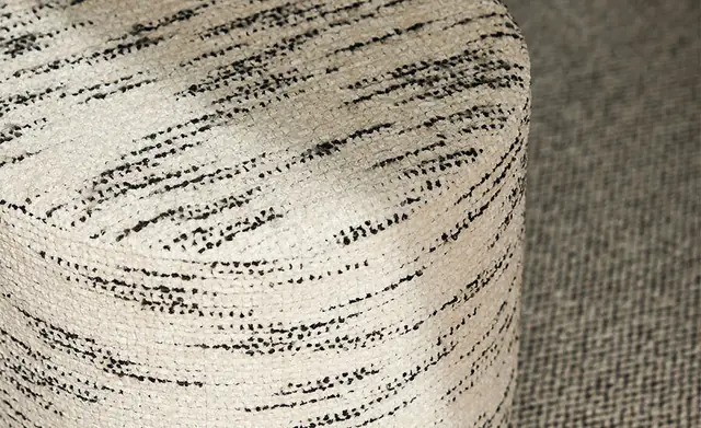 Stack of cushions showing looped, woven, ribbed and patterned textured fabrics