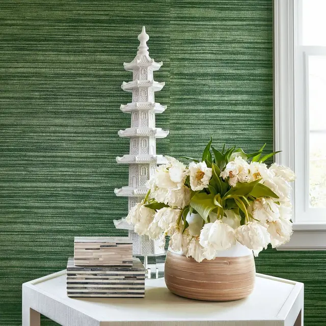 Deep green textured Gaya wallpaper styled with flowers and decorative objects