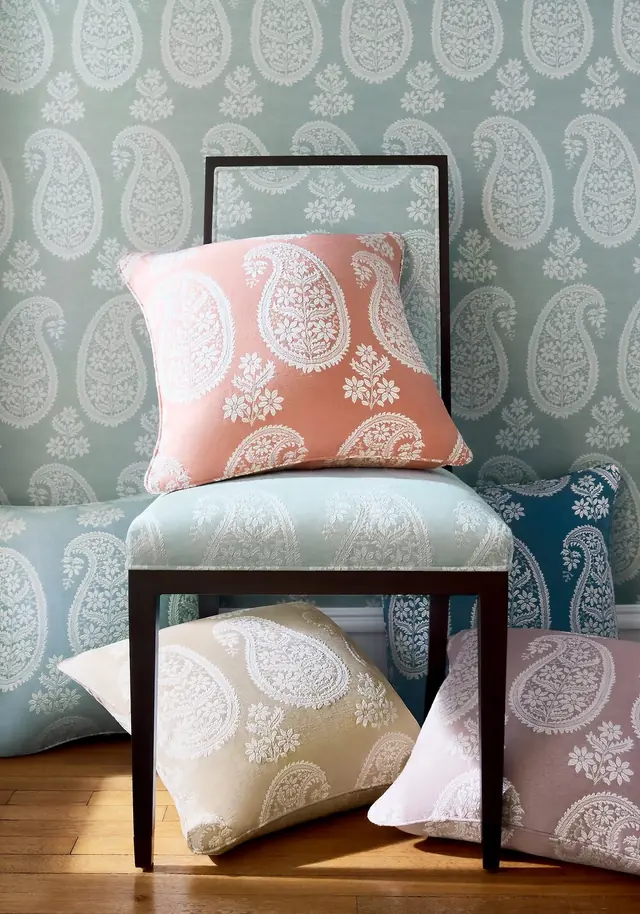 Contemporary paisley fabrics and cushions in coral, blue and soft neutral colours