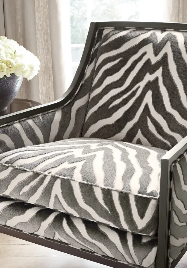 Close view of grey and white animal print velvet on an upholstered chair