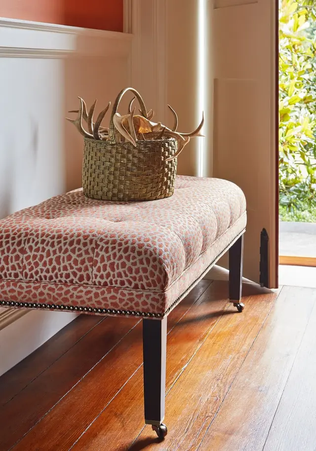 Bench upholstered in rust and cream Thibaut Masai animal print fabric