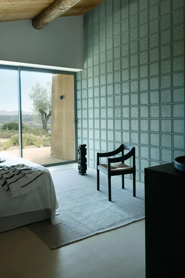 Blue green 3D wallpaper with raised square relief in a bedroom