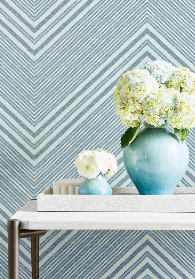 Pale blue geometric wallpaper with layered linear pattern