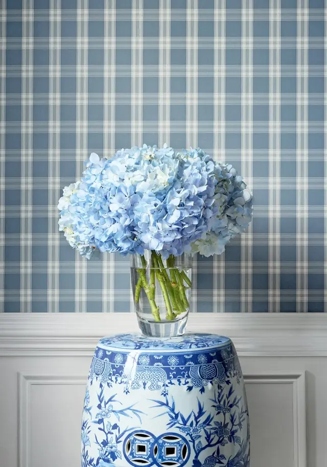 Pale blue checked wallpaper with blue hydrangeas in a light interior
