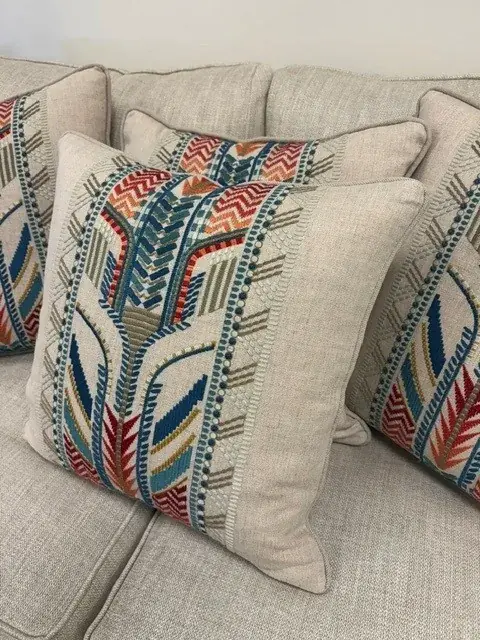 Close-up of a bespoke embroidered cushion showing careful pattern placement