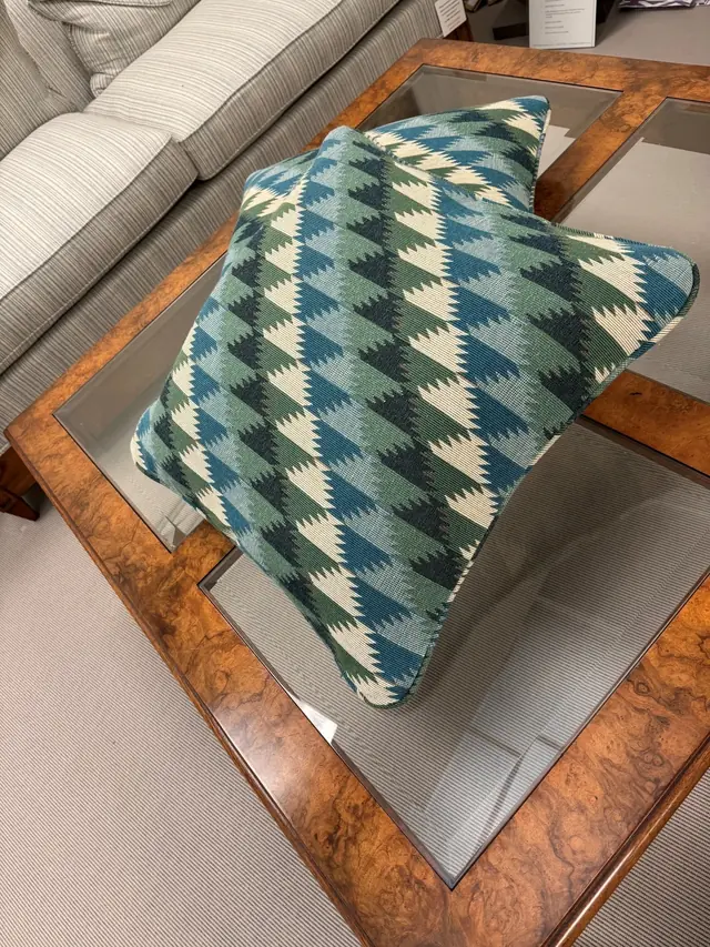 Pair of bespoke patterned cushions made by TM Interiors showing tailored piping and pattern placement