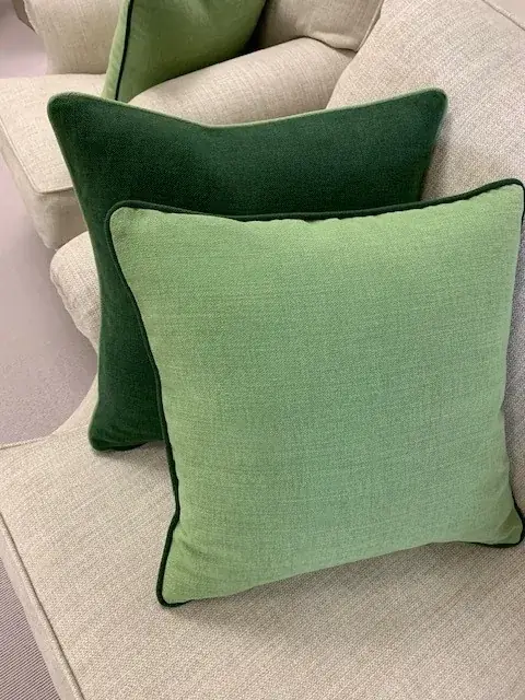 Green bespoke cushions with contrasting piped edges