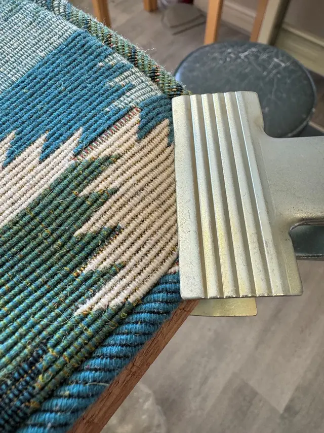 Close-up of blue and green fabric and upholstery detail in the TM Interiors workroom